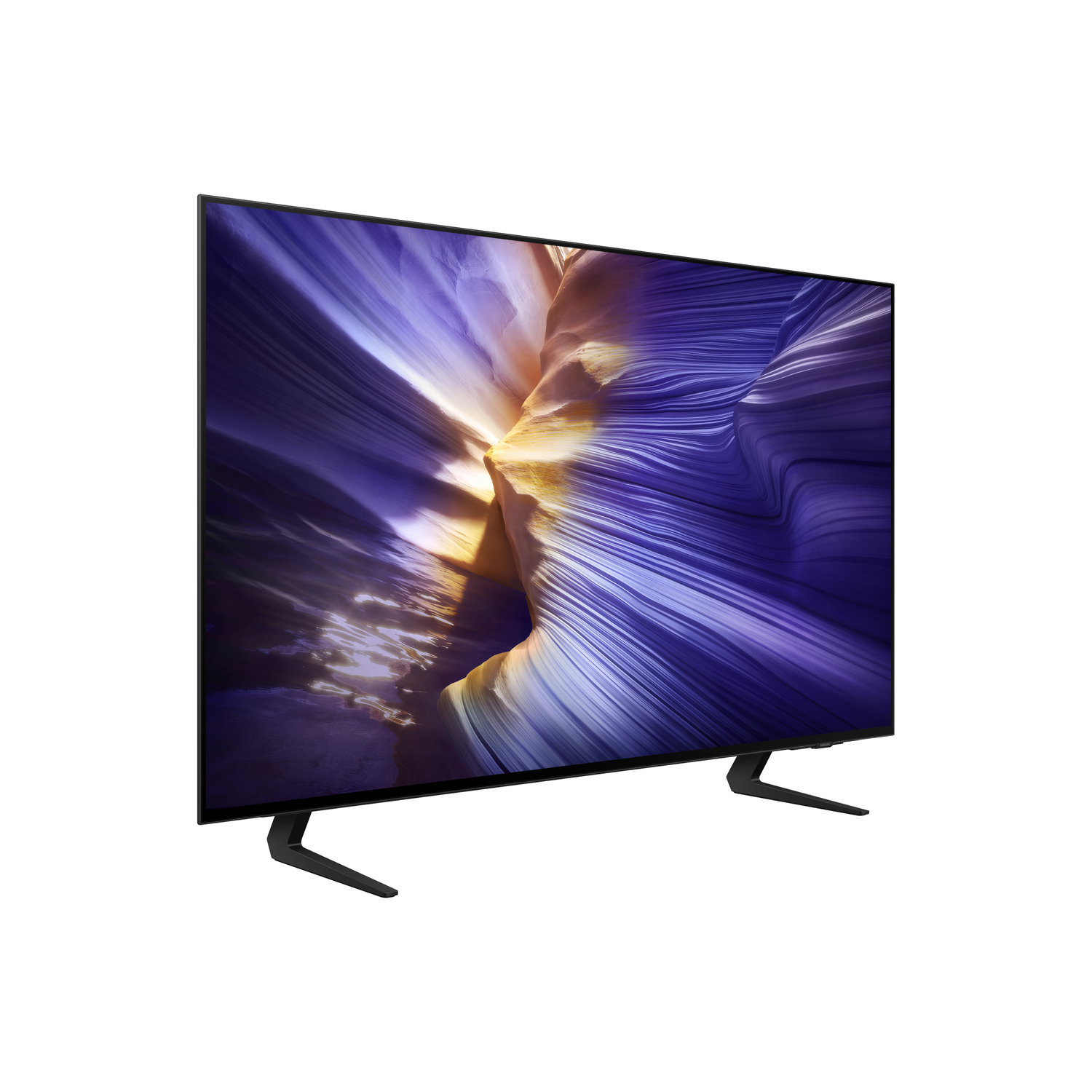 A large, black TV with a vibrant screen displaying a colorful, abstract landscape. It stands on two black, angled legs against white.