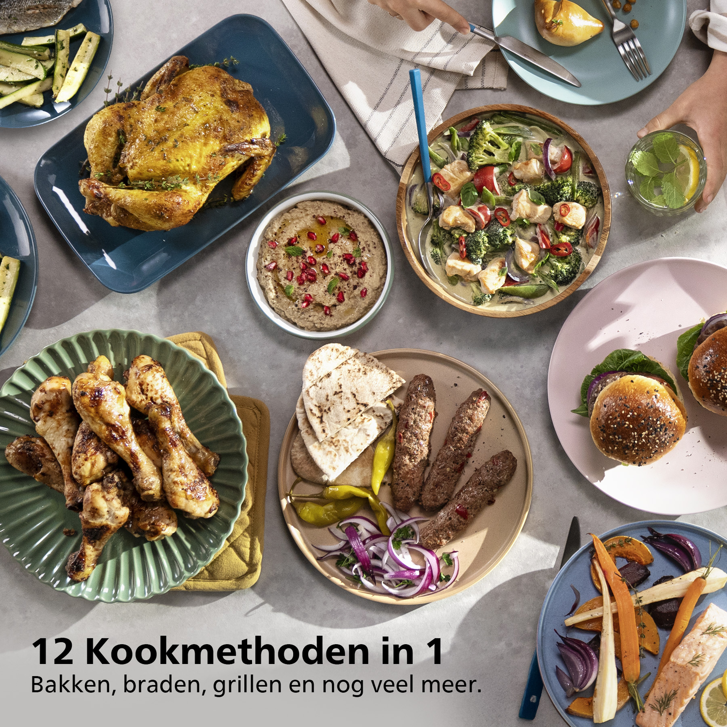 A table is set with various dishes: roasted chicken, soup, grilled meats, vegetables, and burgers. Hands are reaching for food.