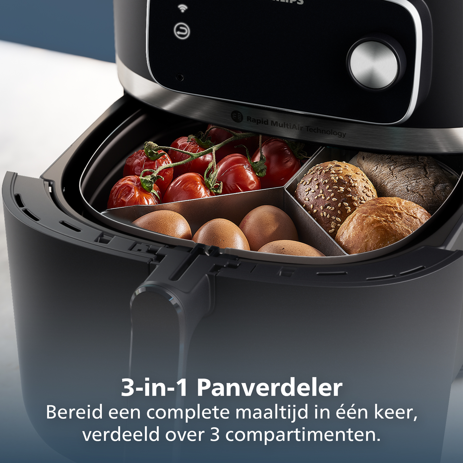 An air fryer with three compartments, filled with tomatoes, eggs, and bread. The top has a control panel.