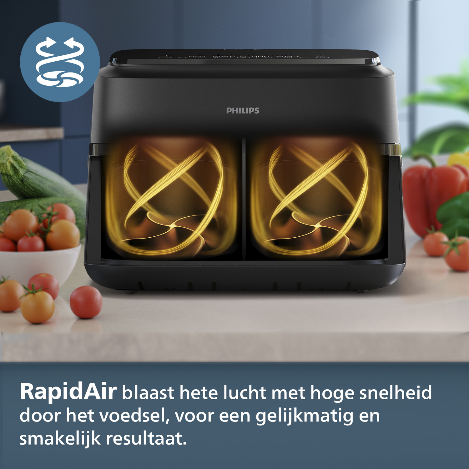 Zwarte Philips airfryer met interne verwarmingselementen. Groenten zoals tomaten en paprika op de achtergrond.