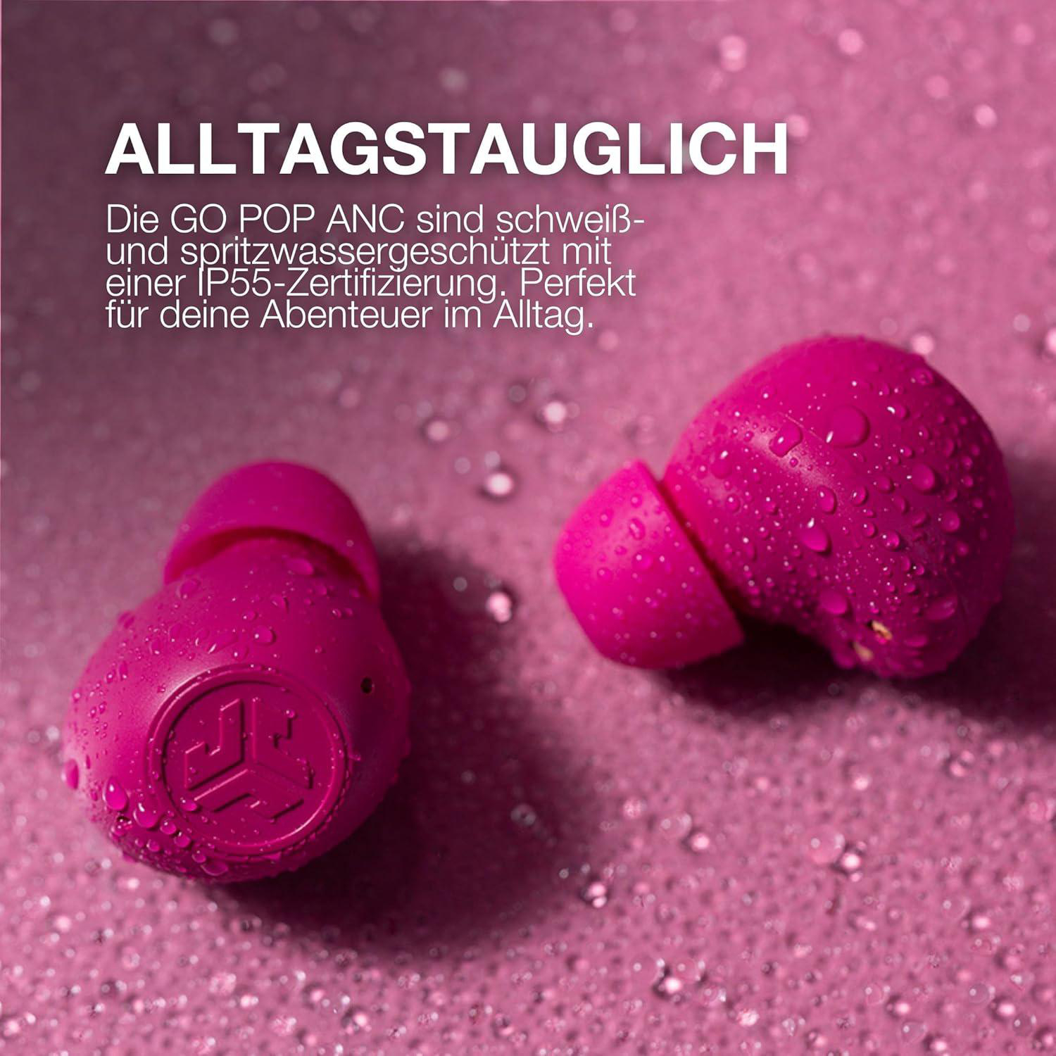 Pinke Ohrhörer mit Wassertropfen auf pinkem Hintergrund. Text oben: ALLTAGSTAUGLICH.