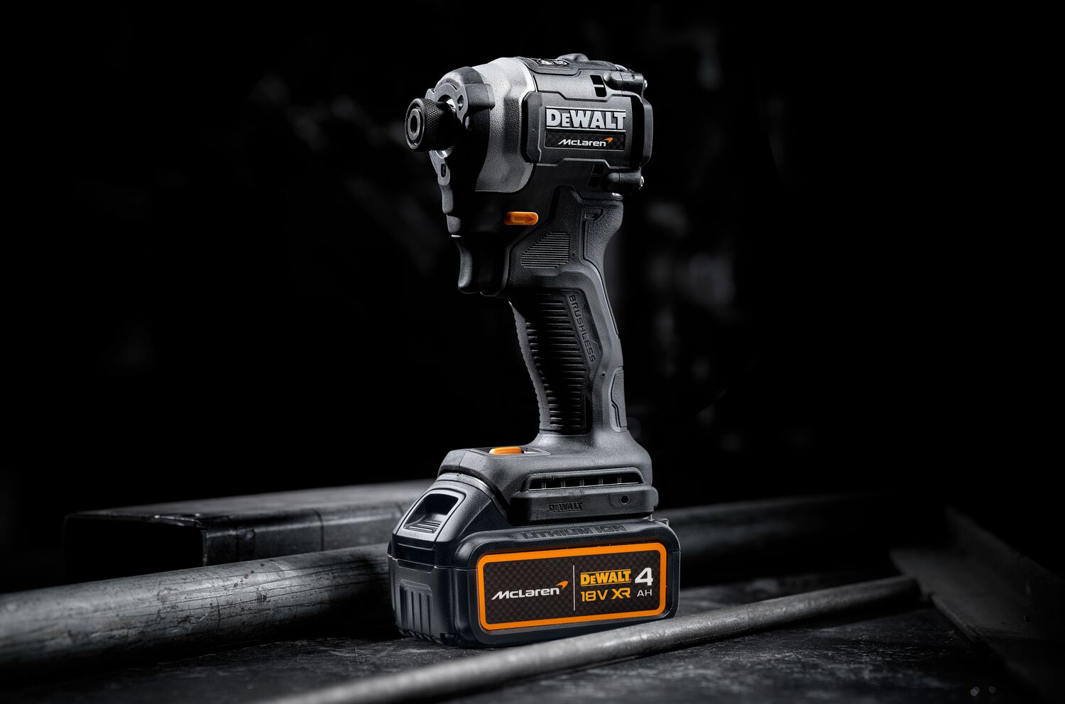 Egy fekete DeWalt McLaren ütvecsavarozó sötét felületen. Az akkumulátoron egy narancssárga-fekete McLaren logó, egy DeWalt 4 logó található.