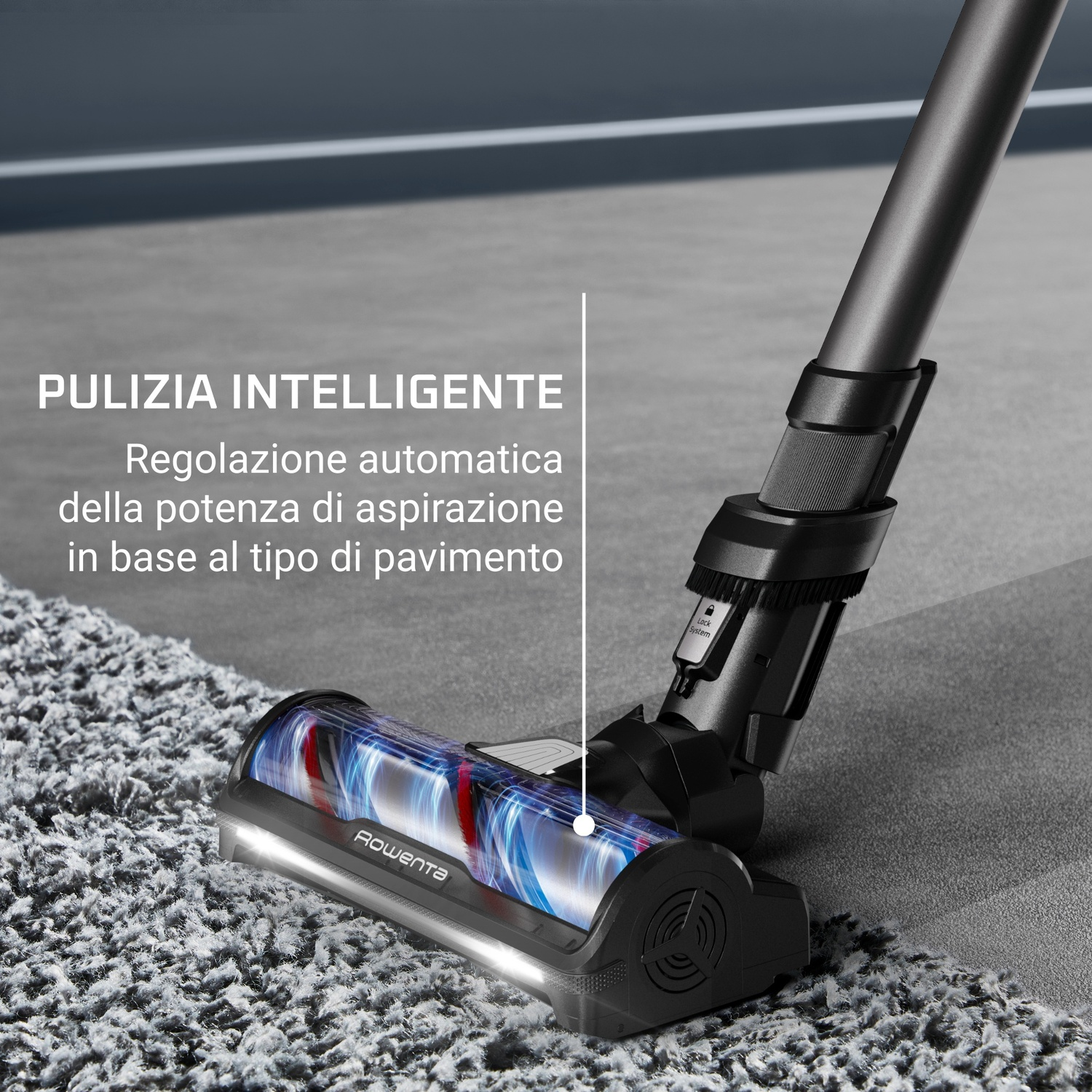 Una testina nera per aspirapolvere pulisce un tappeto grigio. Luci blu e rosse brillano all'interno. Il testo dice 'pulizia intelligente'.