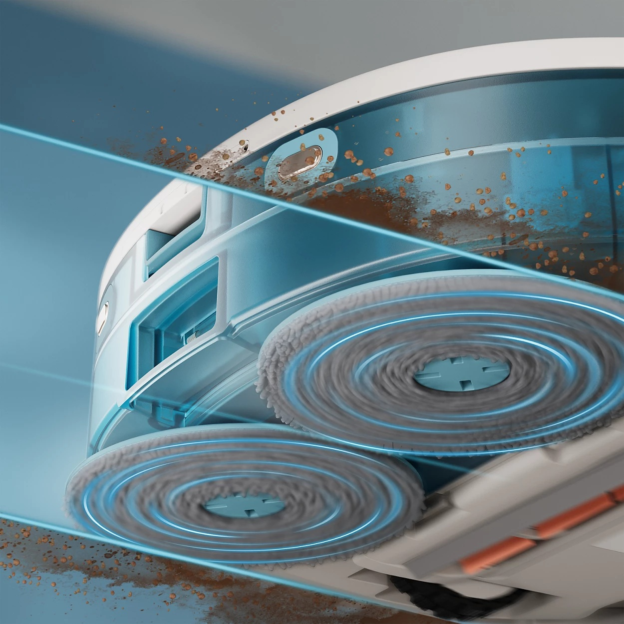 Zbliżenie robota odkurzającego. Widoczne są szare szczotki, niebieskie akcenty i cząsteczki brudu, podkreślające działanie czyszczące.