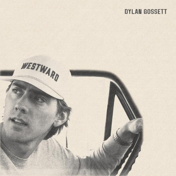 Ein Mann mit einer "WESTWARD"-Kappe, der nach links schaut und ein Lenkrad hält. "DYLAN GOSSETT" steht oben.
