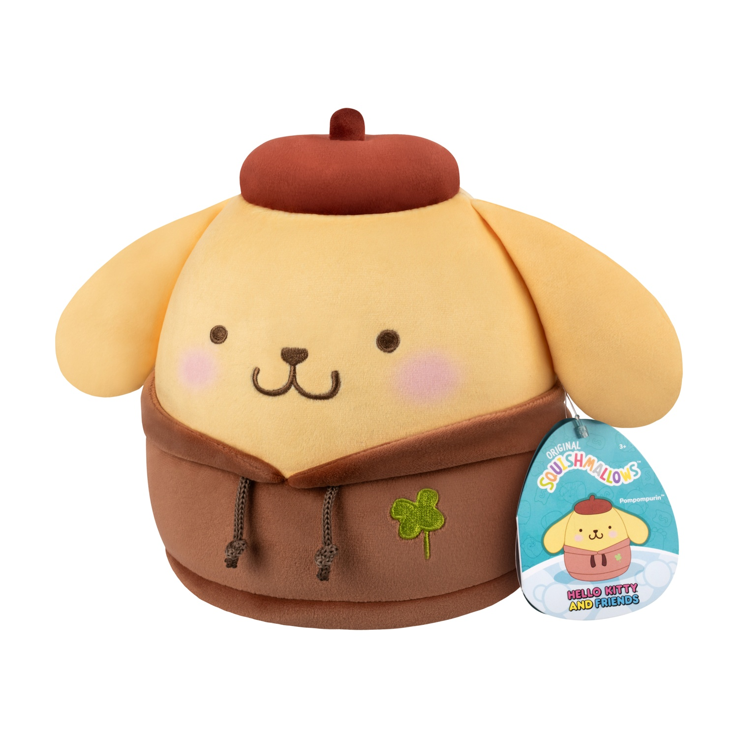 Un peluche di Pompompurin con basco e felpa marroni. Ha un quadrifoglio e un'etichetta Squishmallows.