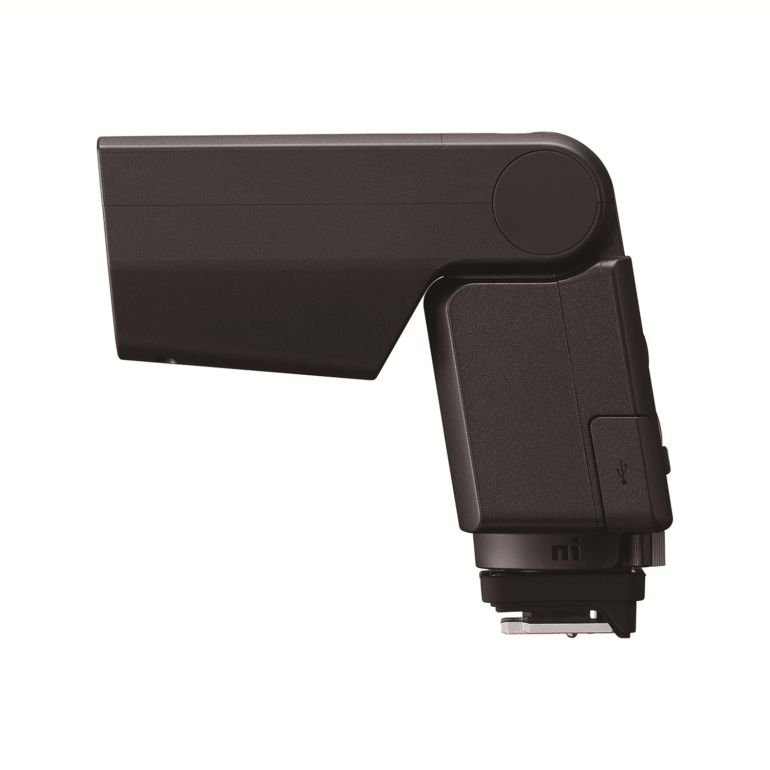 Un flash della fotocamera grigio scuro. Il flash ha una forma a L con un pulsante rotondo sulla parte superiore. Il flash ha una porta USB.