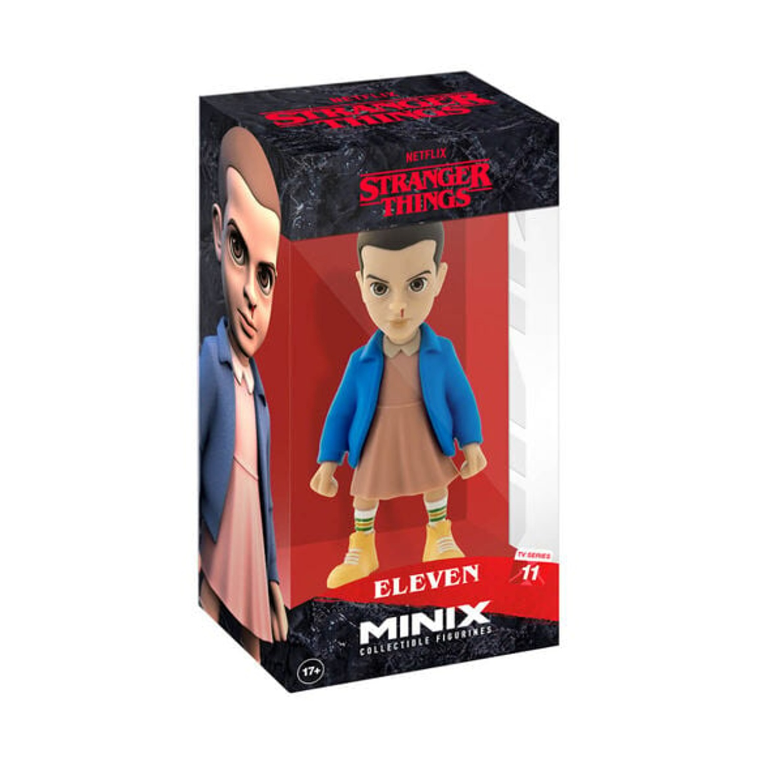 Una statuetta di Eleven di 'Stranger Things' in una scatola. Eleven indossa una giacca blu, un vestito rosa e stivali gialli. La scatola ha il logo dello show.