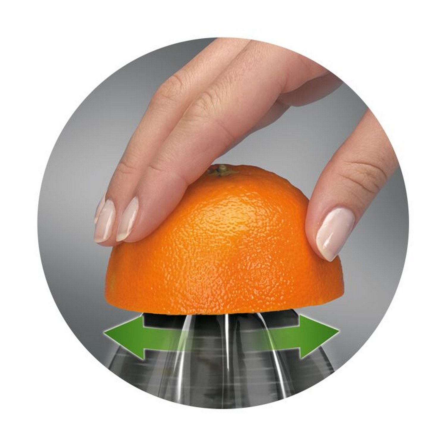 Una mano presiona media naranja sobre un exprimidor. Flechas verdes indican la dirección. El fondo es gris.