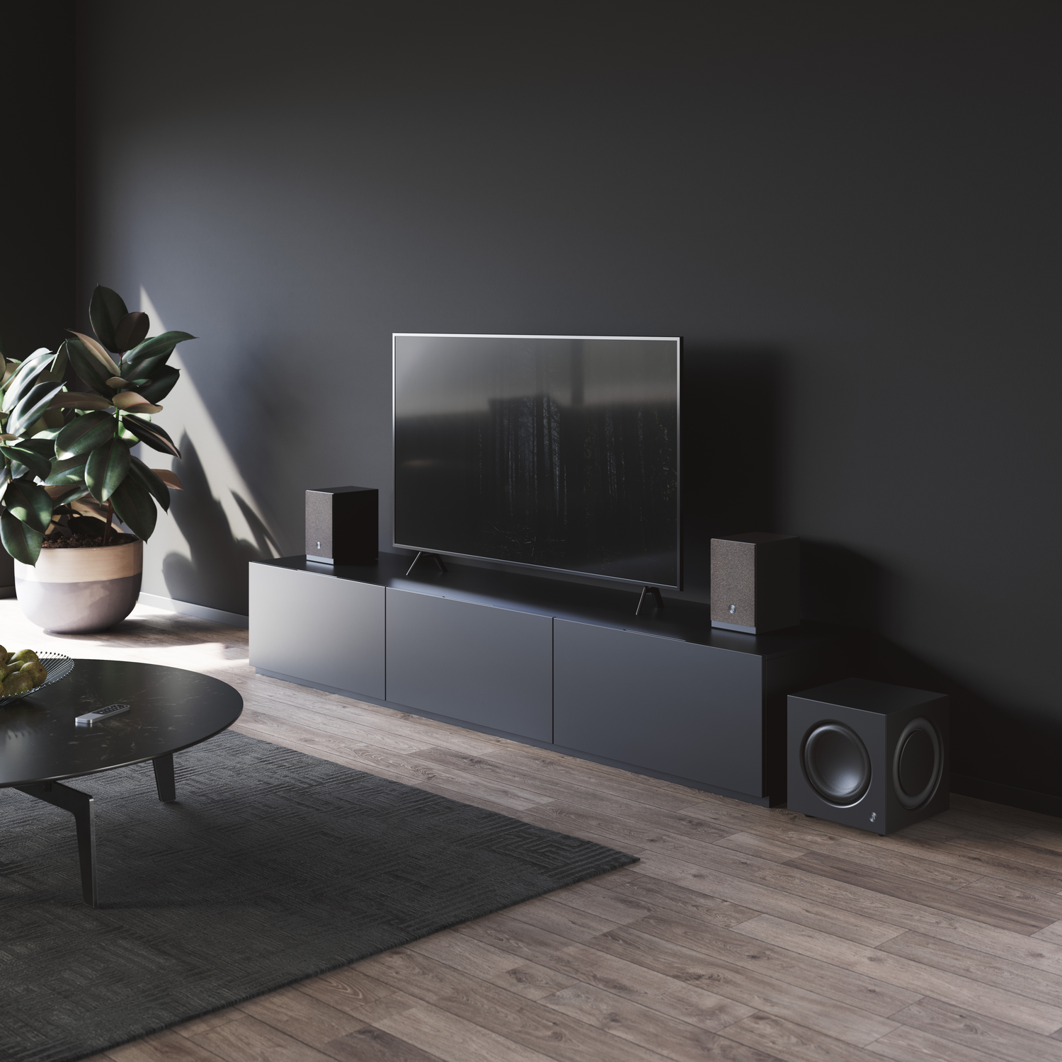 A modern living room with dark grey walls, a large TV, speakers, and a subwoofer. A plant and coffee table are also in the room.