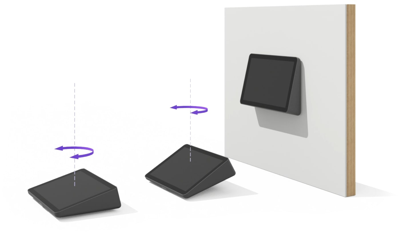 Ein Tablet dreht sich von einem Sockel, um an einer weißen Wand befestigt zu werden. Pfeile zeigen die Bewegung an. Das Tablet ist schwarz.