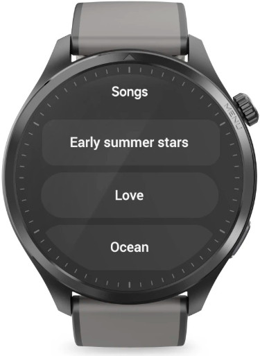 Smartwatch wyświetla menu muzyczne. Opcje to 'Songs', 'Early summer stars', 'Love' i 'Ocean'. Zegarek jest czarny z szarym paskiem.