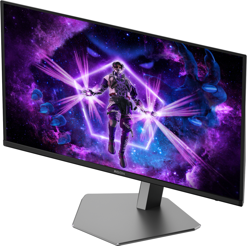 Un moniteur affiche une figure futuriste au milieu d'une galaxie violette. Le moniteur a un cadre noir et un support argenté.