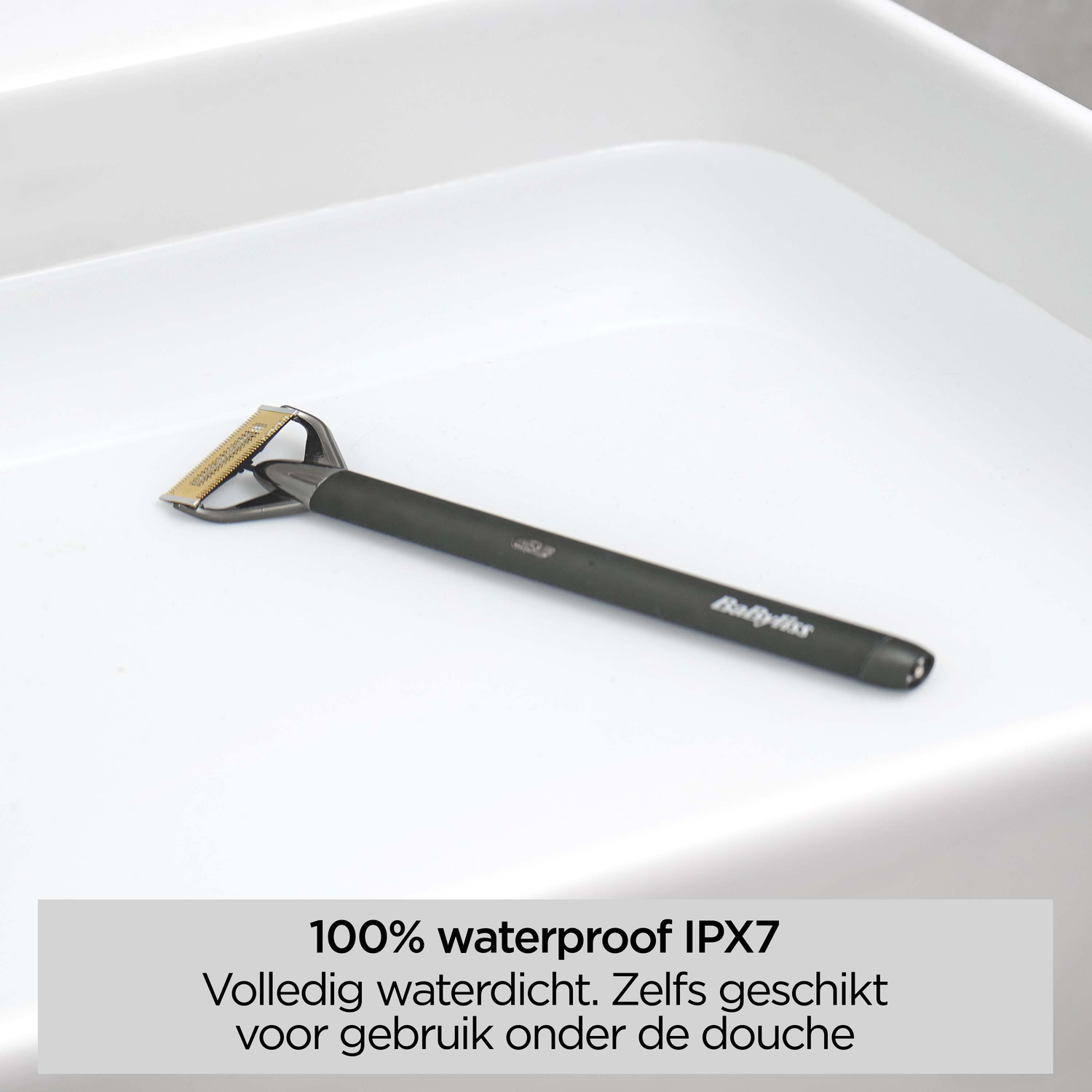 A black and silver Babyliss razor on a white surface. Text at the bottom says '100% waterproof IPX7'.