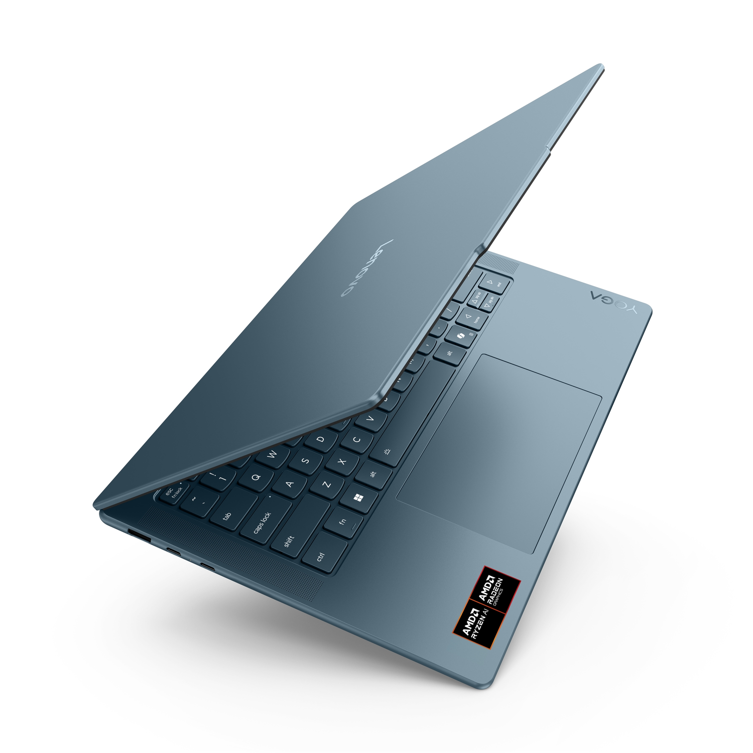 A blue Lenovo Yoga laptop is slightly open, showing the keyboard and touchpad. The AMD Ryzen AI sticker is visible on the bottom right.