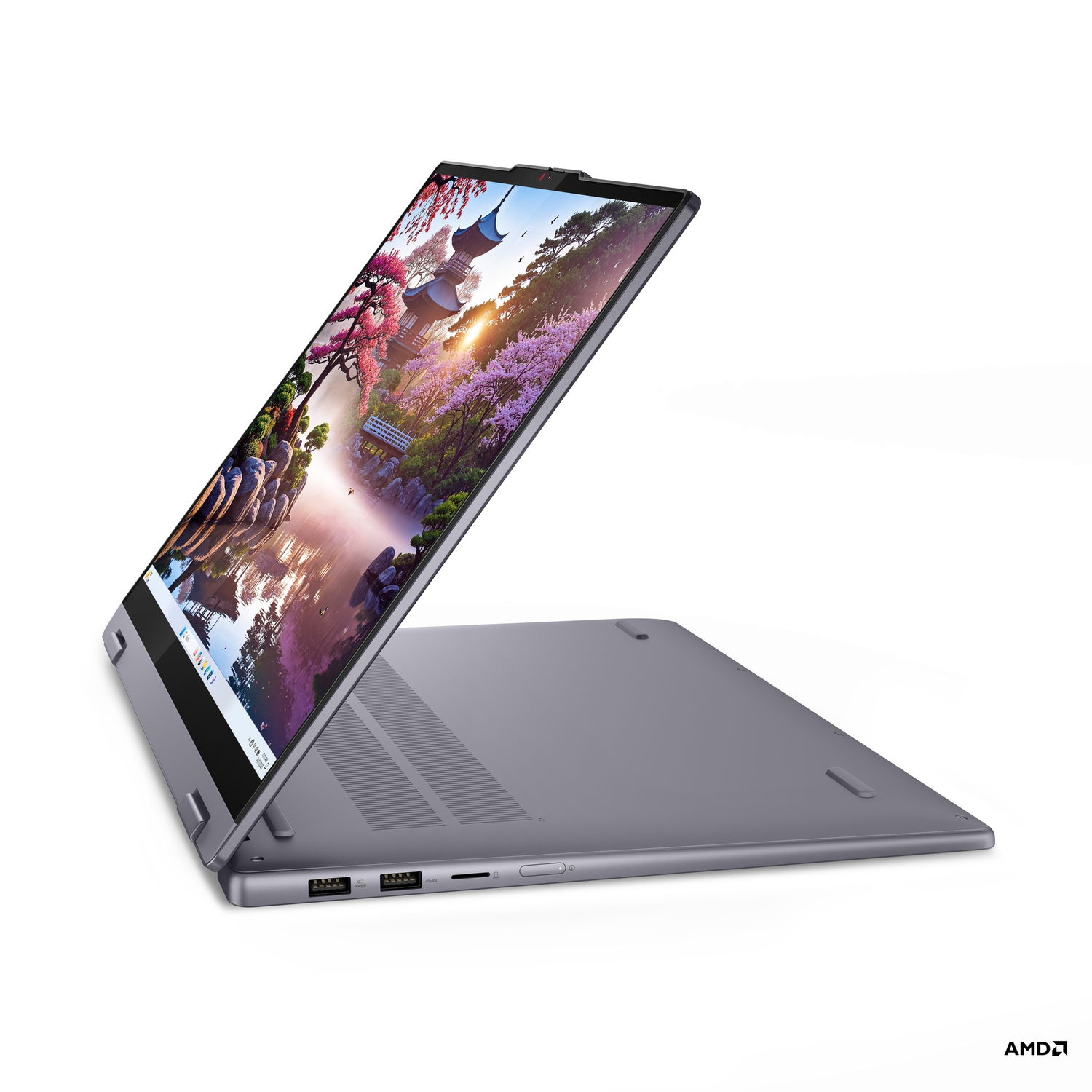 Een grijze laptop is open en toont een schilderachtig beeld van een Japanse tuin. De laptop staat op een witte ondergrond. Het AMD-logo is zichtbaar.