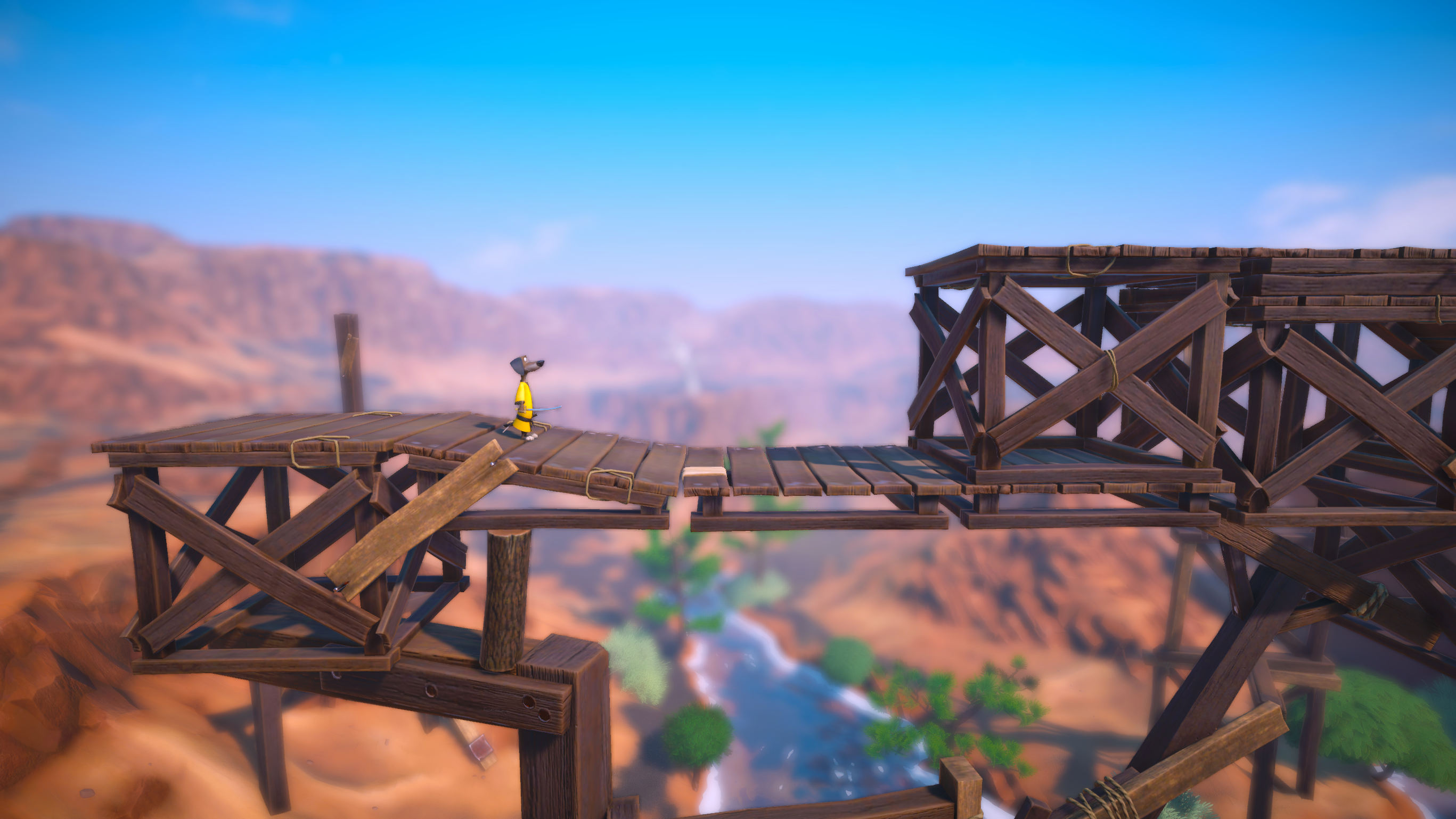Un personaje de dibujos animados de amarillo está en un puente de madera, con una sección rota. El fondo es un cañón con un río.