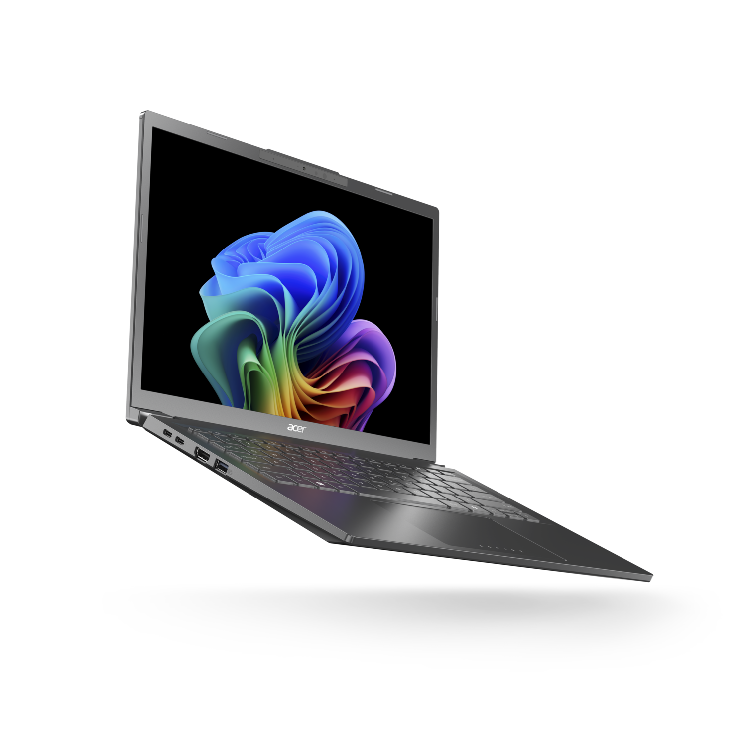 A silver Acer laptop displays a colorful abstract image on a black background. The laptop is slightly angled.