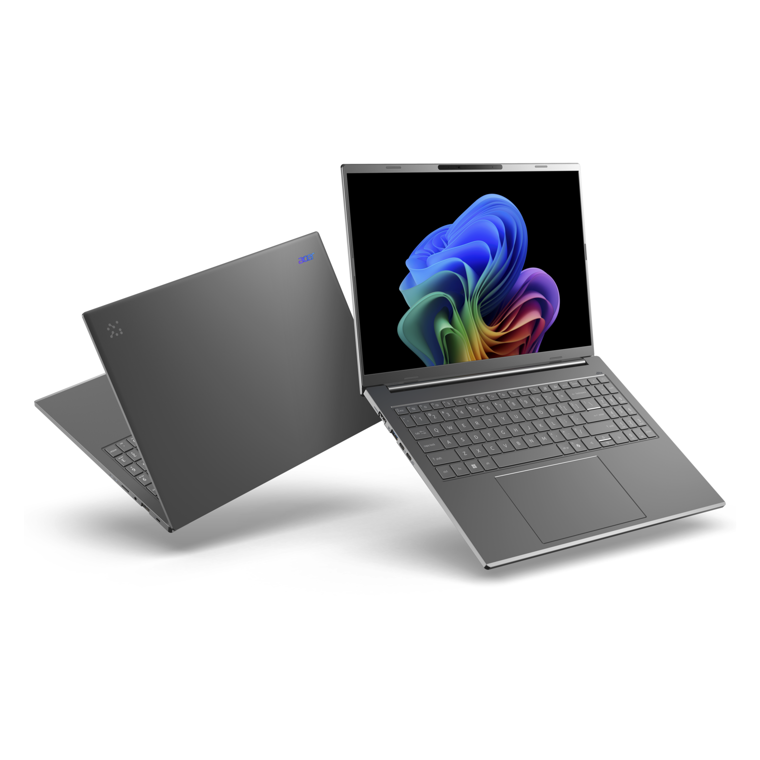 Two gray laptops are displayed. One is open, showing a colorful abstract image on the screen, the other is closed and in the background.