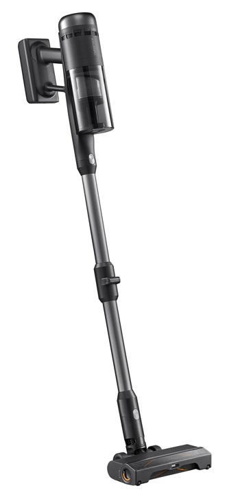 Czarno-szary odkurzacz bezprzewodowy na białym tle. Jest zamontowany na ładowarce ściennej.