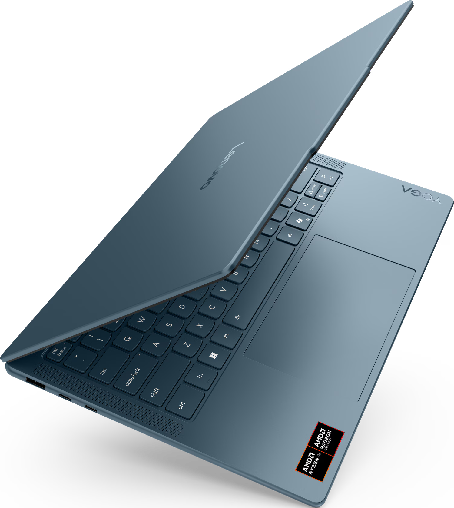 Ordinateur portable Lenovo Yoga bleu sur fond noir, ouvert, montrant clavier et pavé tactile. Autocollants AMD Ryzen et Radeon visibles.