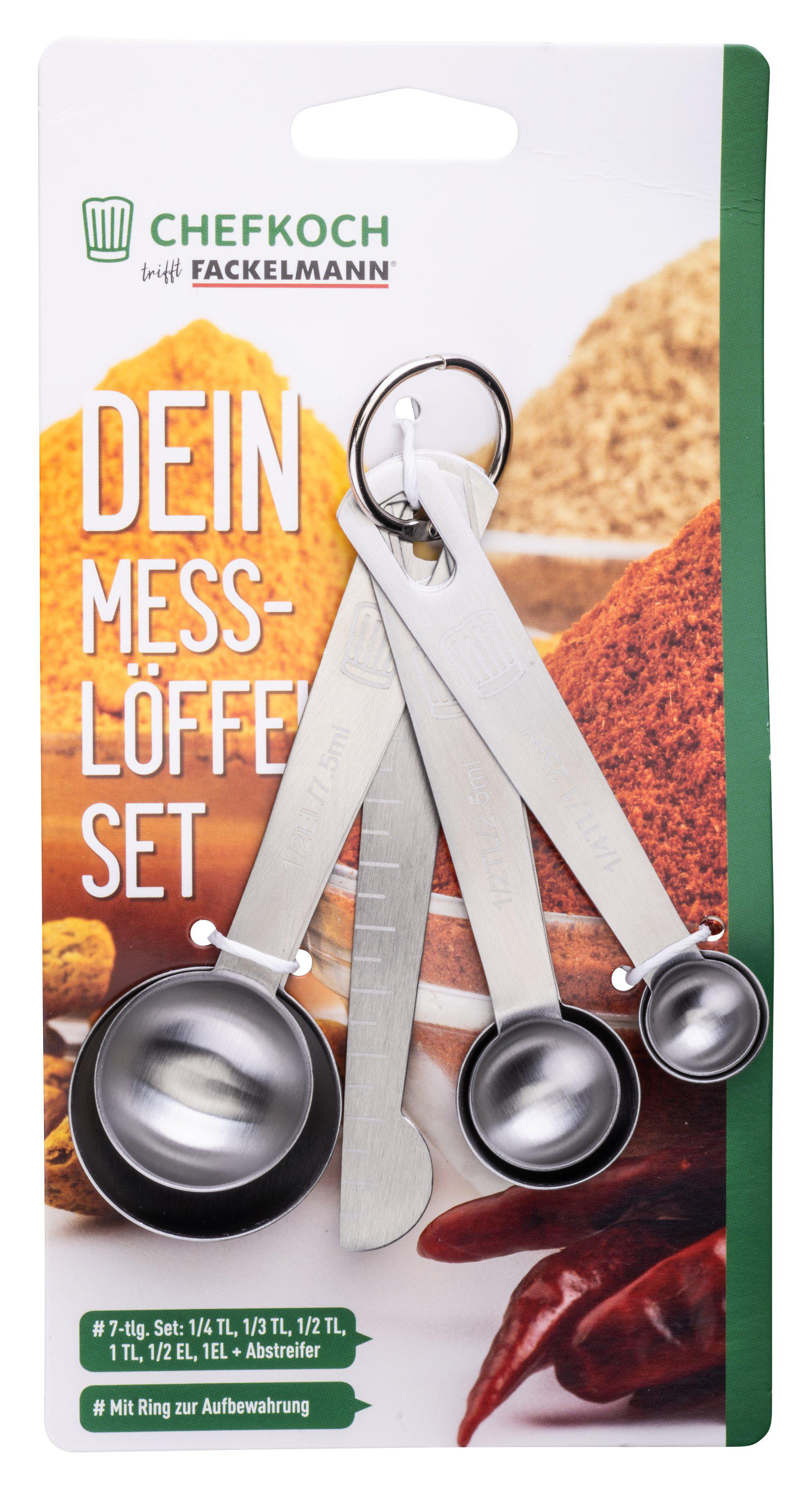 Ein Messlöffel-Set auf einer Karte. Das Set enthält mehrere Edelstahl-Löffel und einen Schaber.