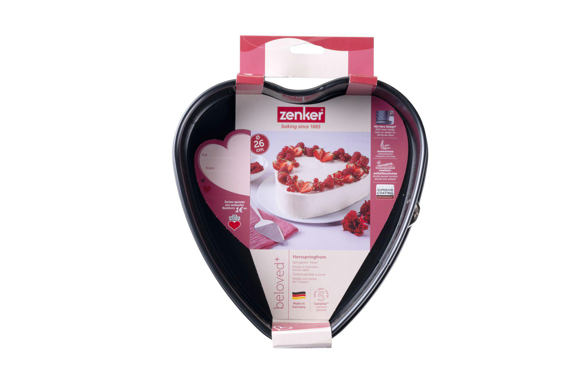 Eine schwarze herzförmige Backform mit Verpackung. Die Verpackung zeigt einen Kuchen, Erdbeeren und den Markennamen Zenker.