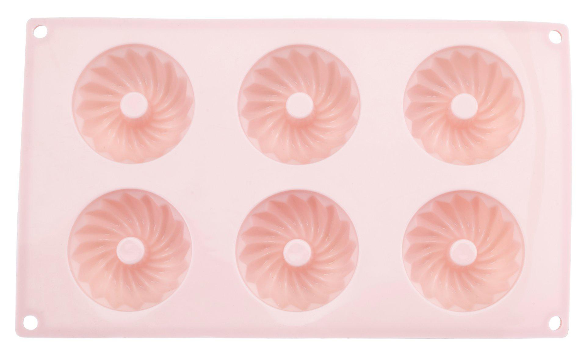 Eine rosa Silikonform mit sechs runden Vertiefungen. Jede Vertiefung hat ein geriffeltes Design und einen Mittelkreis.