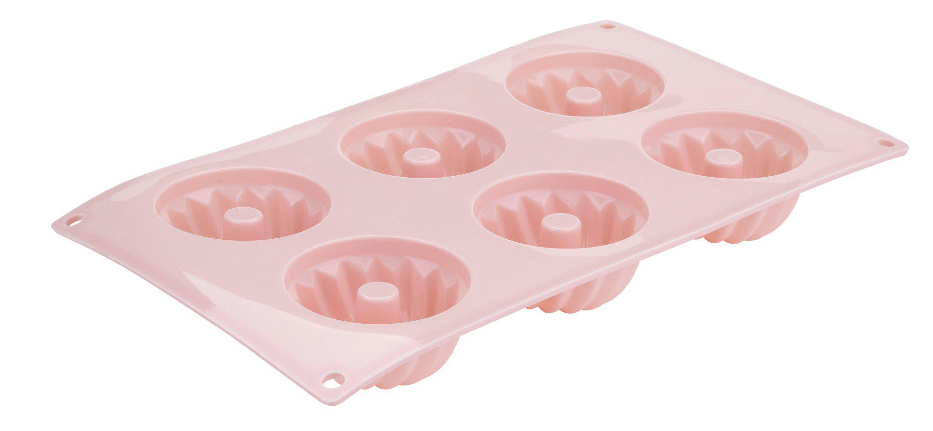 Eine rosa Silikonform für Mini-Kuchen. Sie hat sechs runde Vertiefungen, jede mit einem zentralen Kegel.