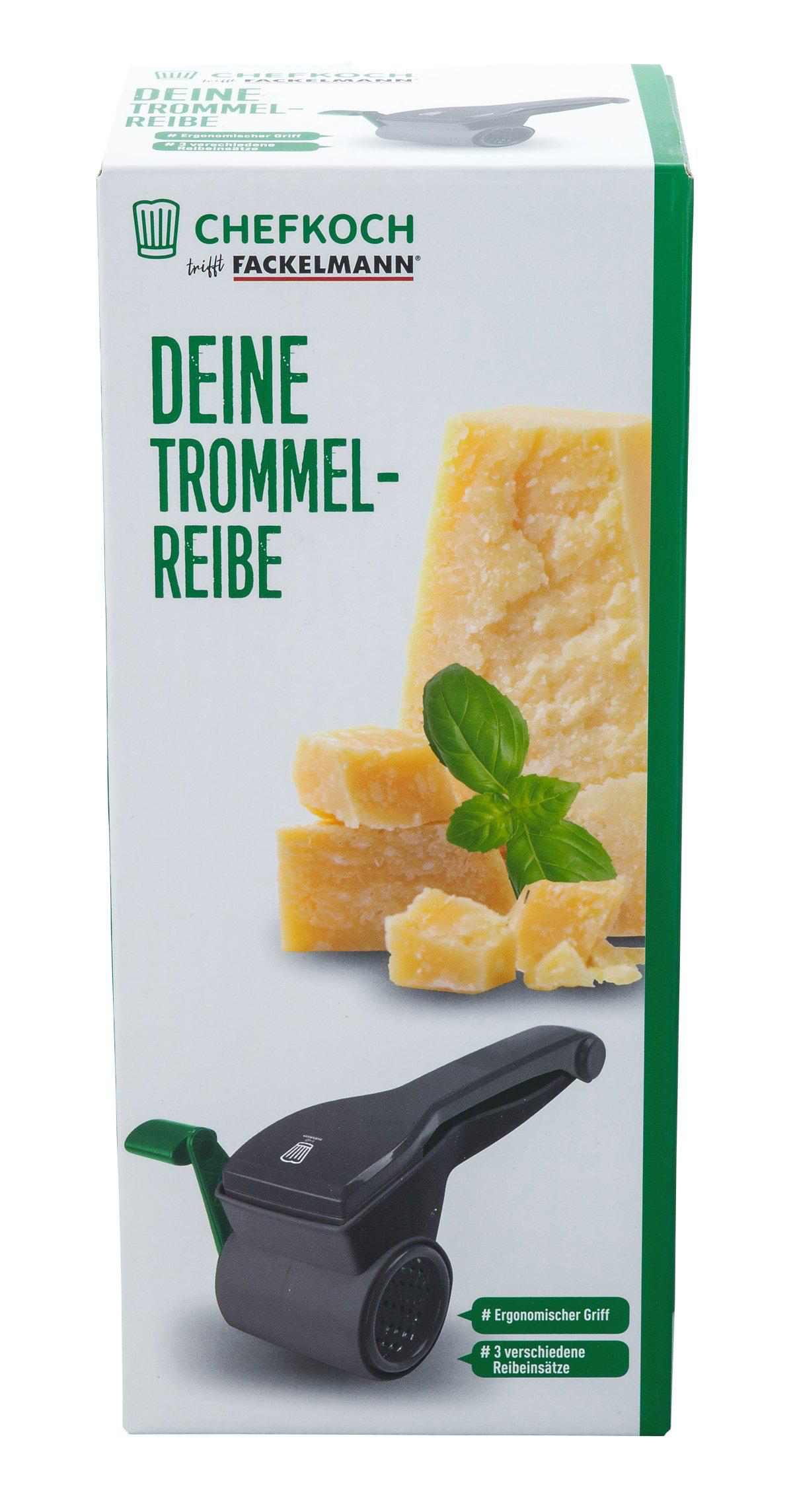 Box mit Käse und Reibe. Auf der Box steht 'Deine Trommel-Reibe'. Käsebrocken und Basilikum sind sichtbar. Eine schwarze Reibe ist abgebildet.