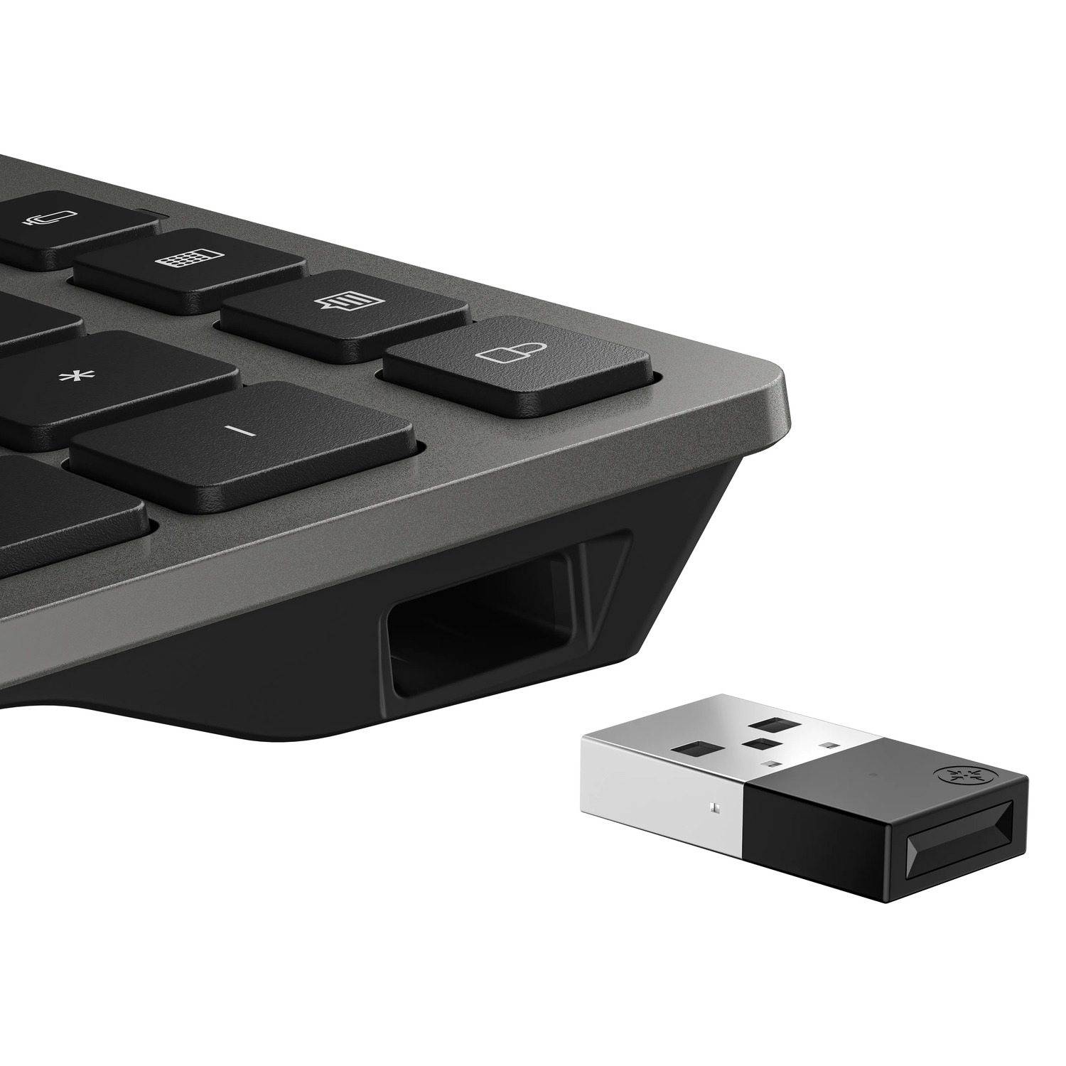 Close-up of a keyboard with black keys and a USB drive. The keyboard is gray, and the USB drive is silver and black.