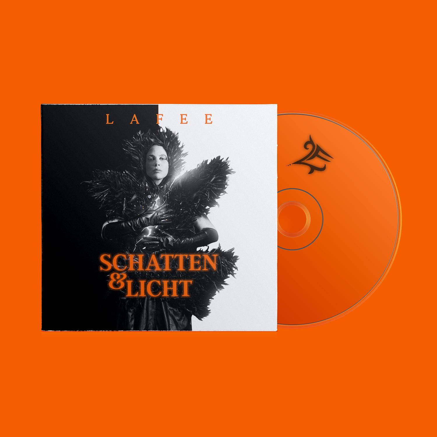 CD-Cover mit einer Frau mit schwarzen Federn, dem Titel 'Schatten & Licht' und einer CD auf orangefarbenem Hintergrund.
