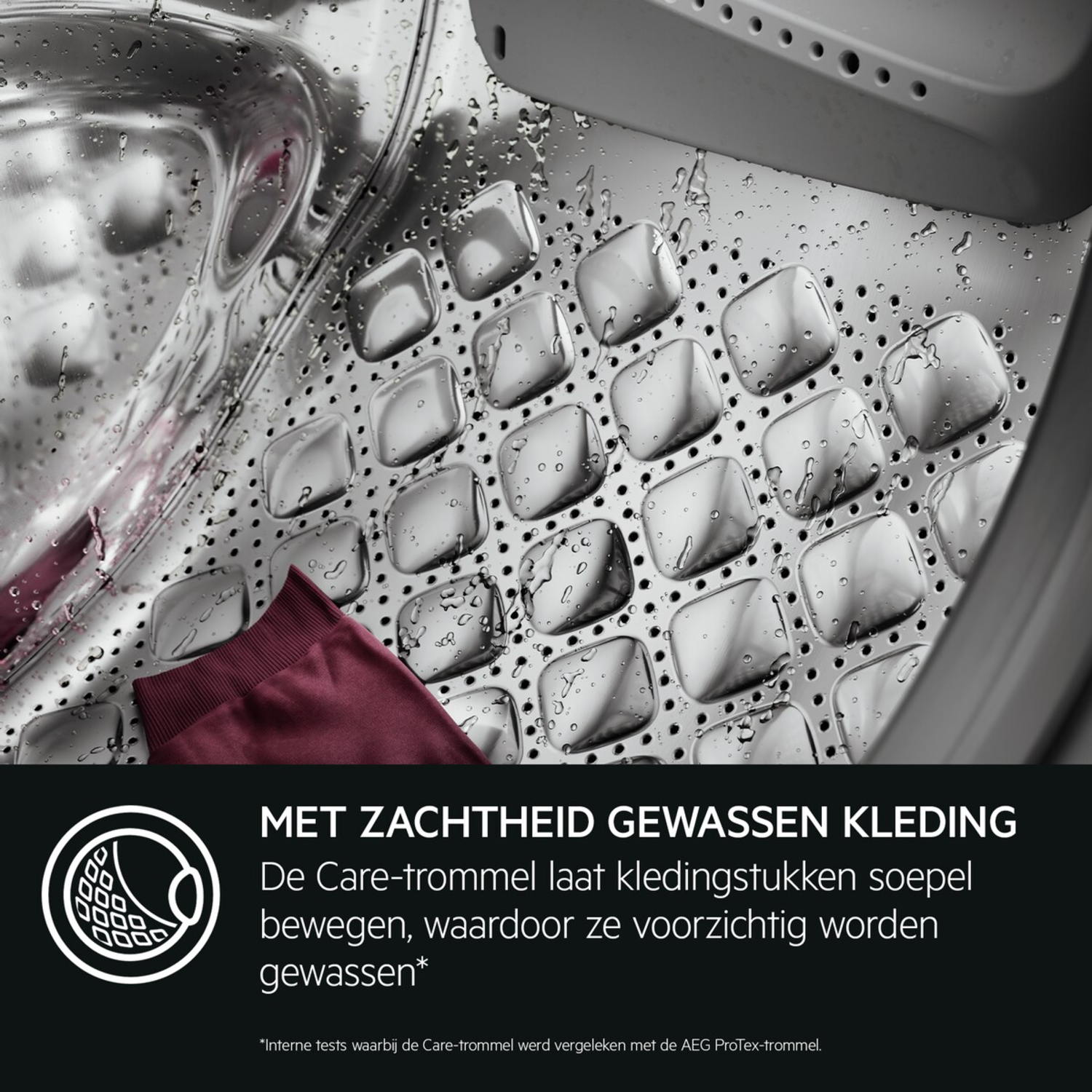 Inside a washing machine drum. A burgundy garment rests on the perforated stainless steel. Water droplets are visible.
