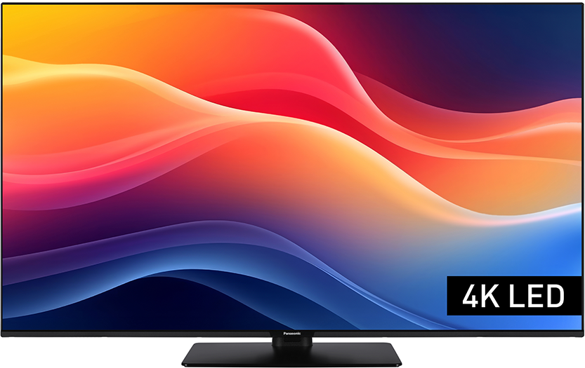 Egy fekete Panasonic 4K LED TV színes absztrakt dizájnt jelenít meg piros, narancs, sárga és kék hullámvonalakkal.