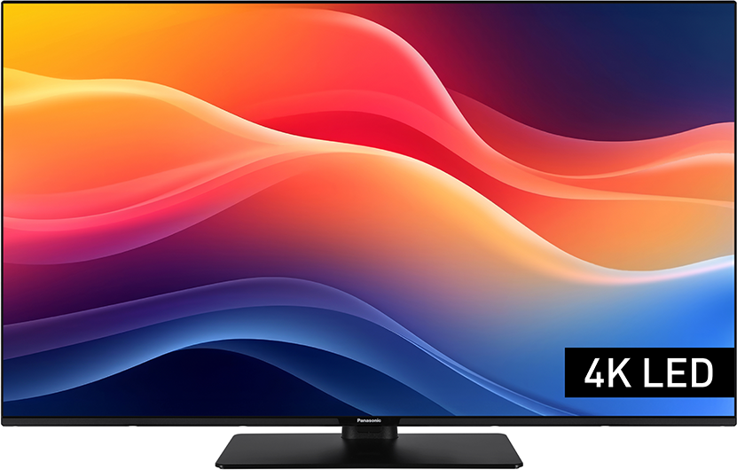 Egy fekete Panasonic 4K LED TV egy absztrakt, színes hullám mintát jelenít meg. A TV egy fekete állványon van.