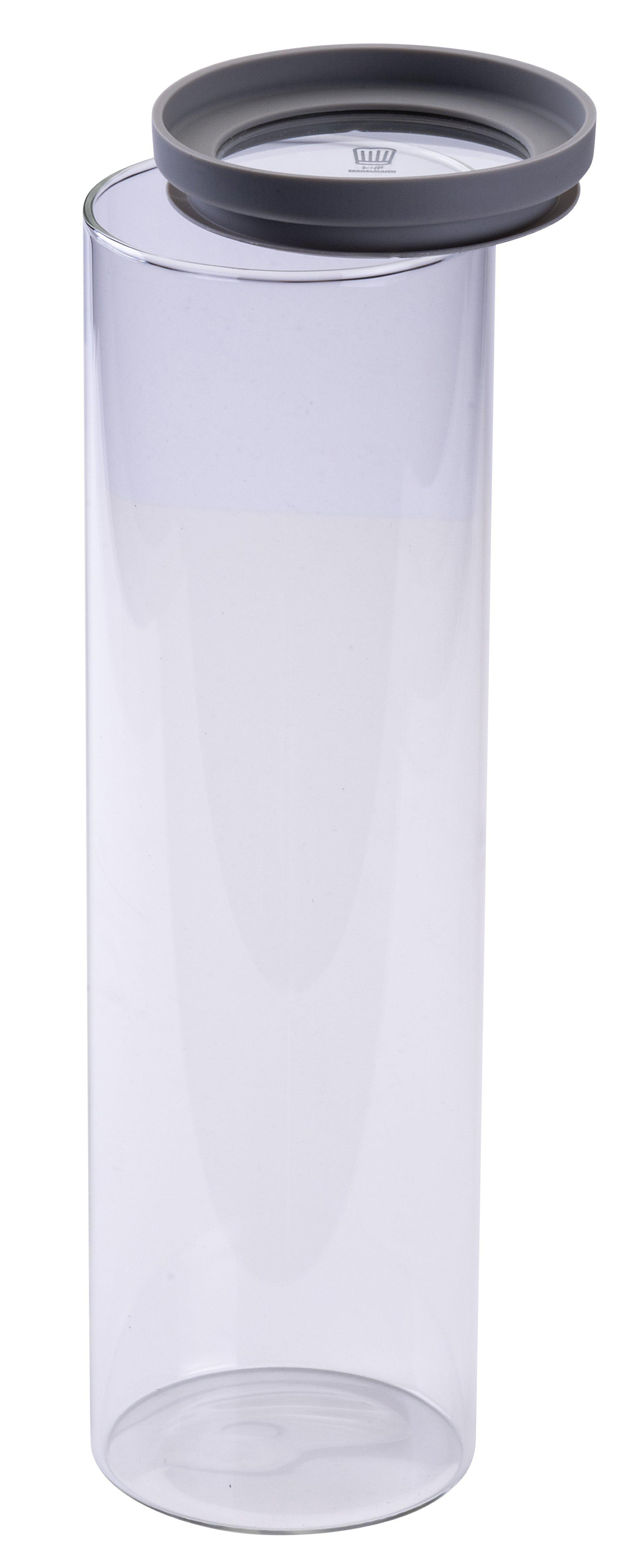 Ein klares Glas mit grauem Deckel ist teilweise geöffnet. Das Glas ist zylindrisch und steht vor weißem Hintergrund.