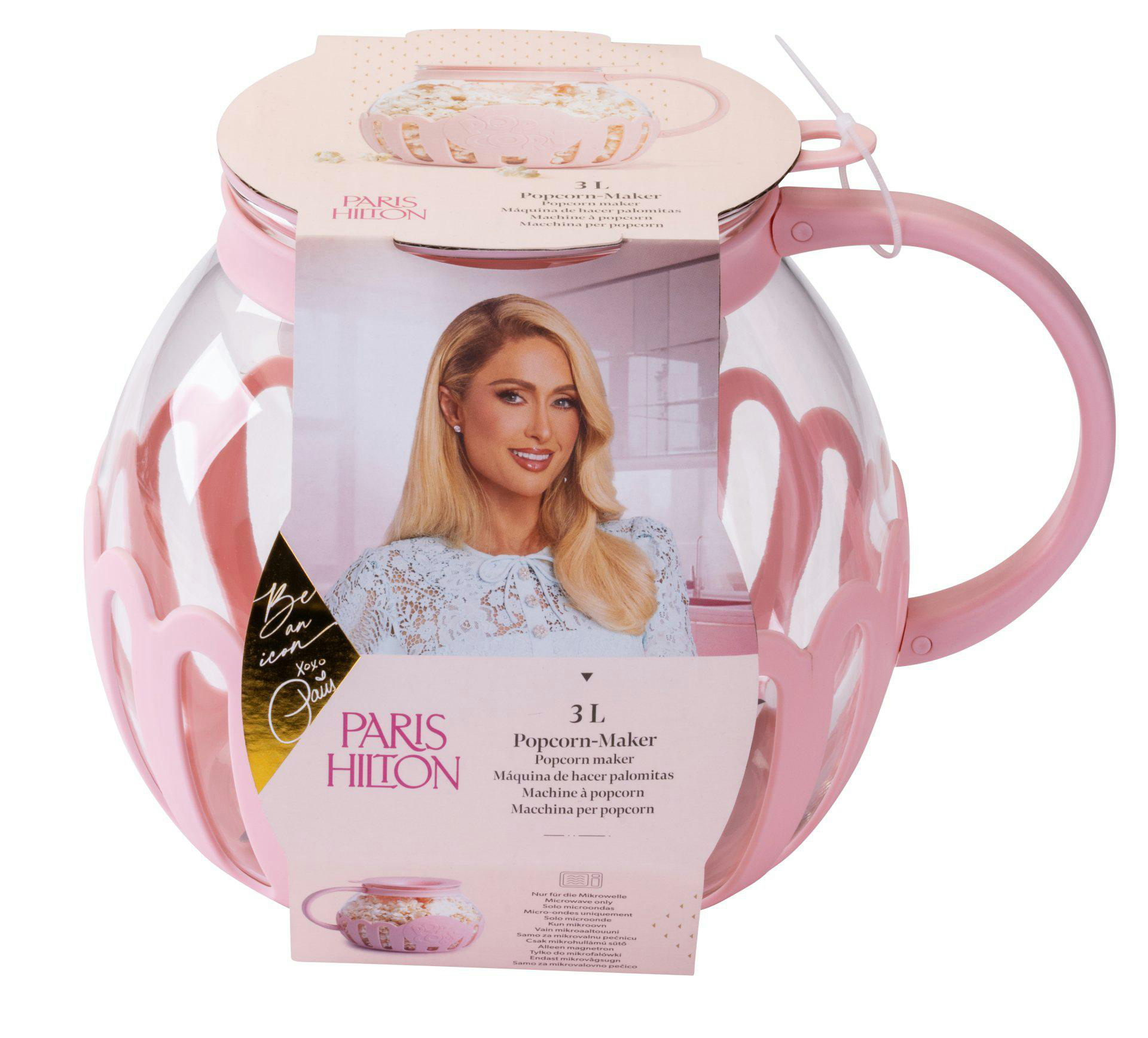 Rosa Popcornmaschine von Paris Hilton. Sie hat einen transparenten Behälter mit rosa Akzenten und einem Griff. Paris Hiltons Bild ist darauf.