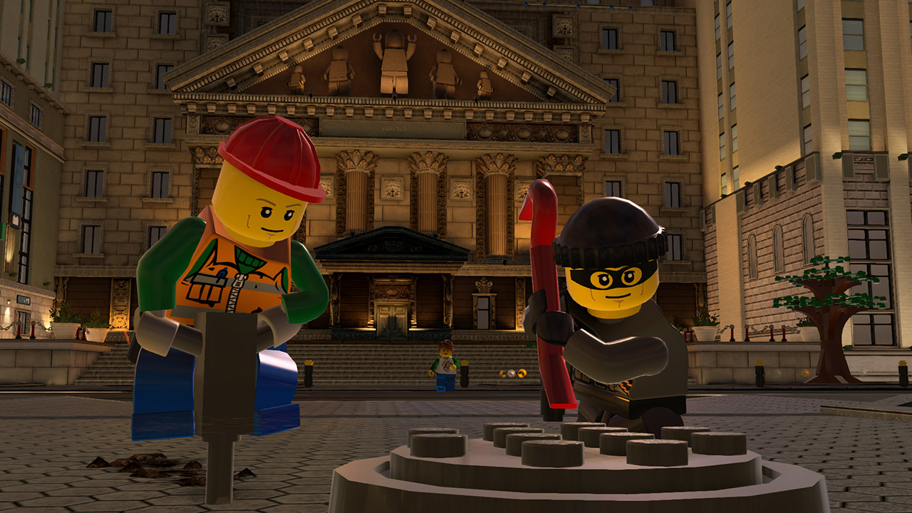 Zwei Lego-Minifiguren, eine mit einem Presslufthammer, die andere mit einem Brecheisen, stehen vor einem Gebäude.