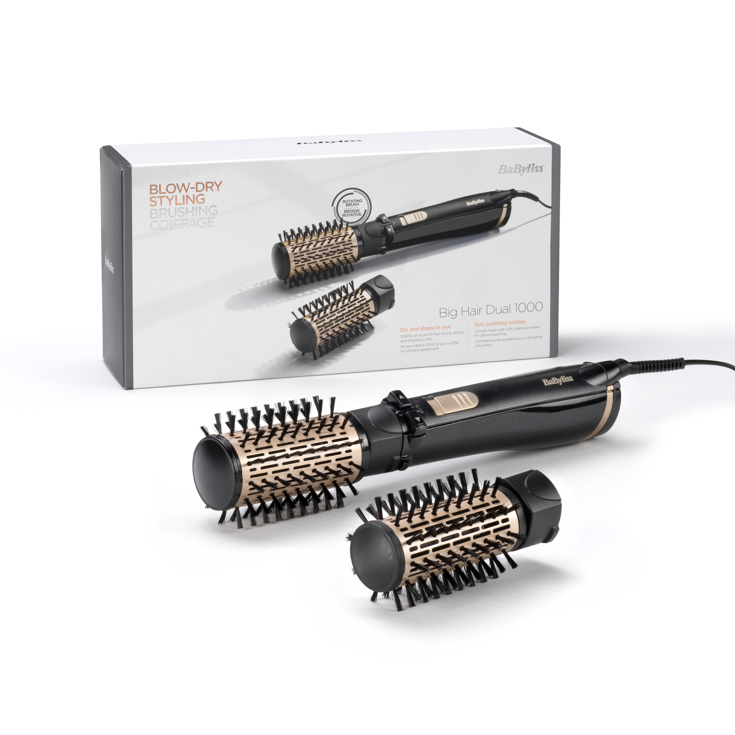 A Babyliss Big Hair Dual 1000 hair styler with two brush heads on a white surface, box in the background.