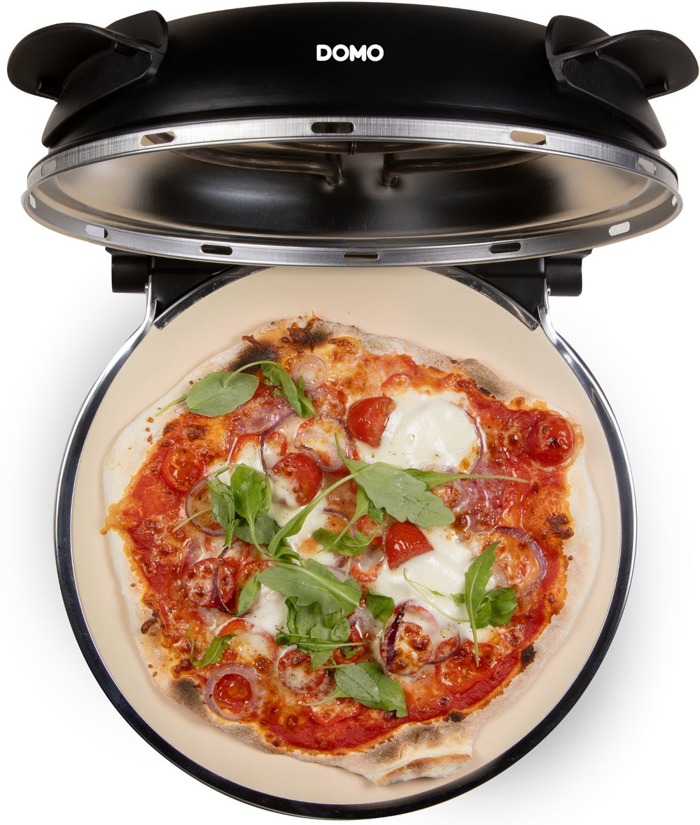 Pizza in a black pizza oven. The pizza has tomatoes, cheese, and basil. The oven is open and has the brand DOMO on it.