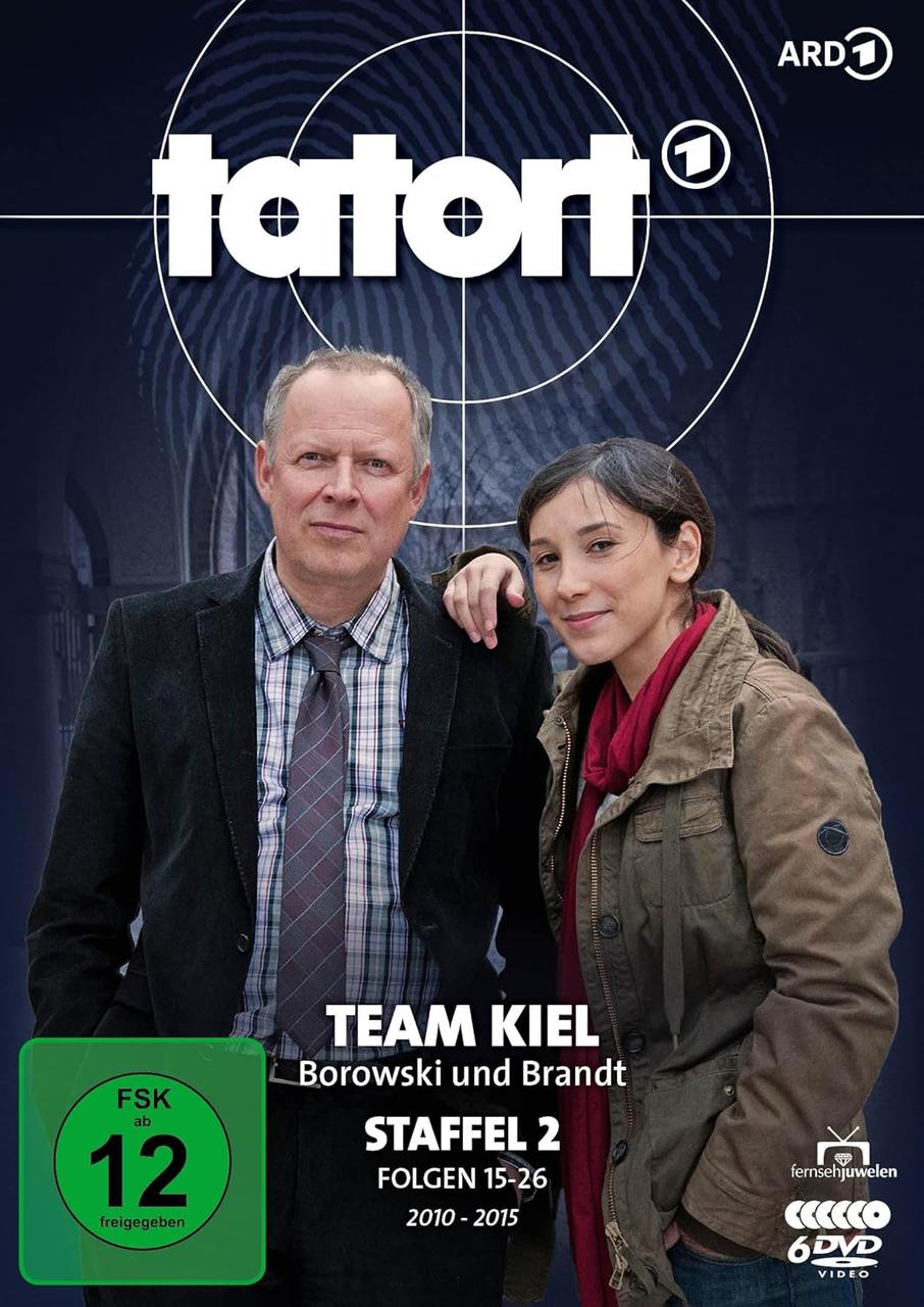 Zwei Personen posieren auf einem DVD-Cover. Text enthält 'Tatort', 'Team Kiel' und 'FSK 12'.