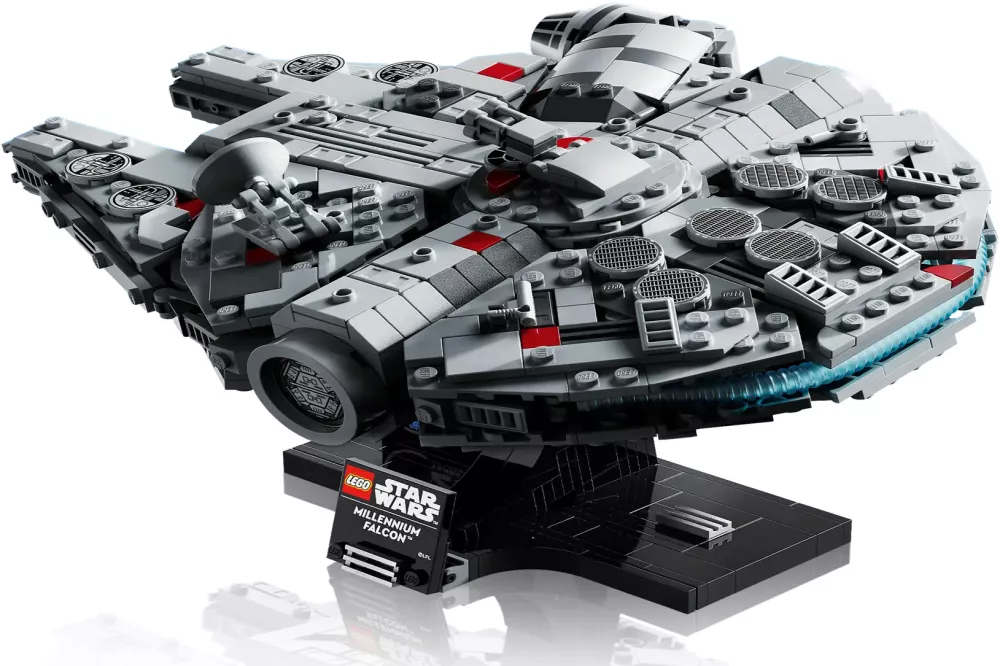 A Lego Star Wars Millennium Falcon model. Gray spaceship with red accents on a black stand. The logo is visible.
