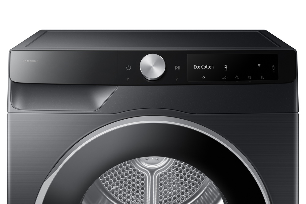 Una secadora Samsung negra con panel de control, dial plateado y puerta redonda. La pantalla muestra 'Eco Cotton' y un número.