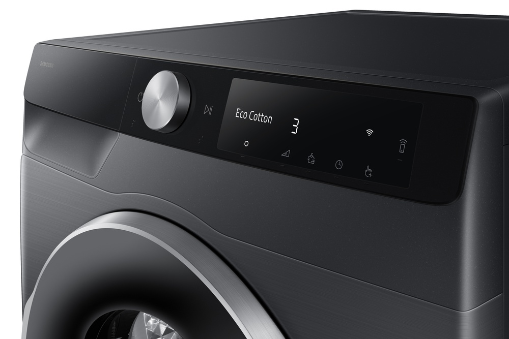 Primer plano de un panel de control de lavadora Samsung gris oscuro. Muestra 'Eco Cotton', el número '3' e iconos.