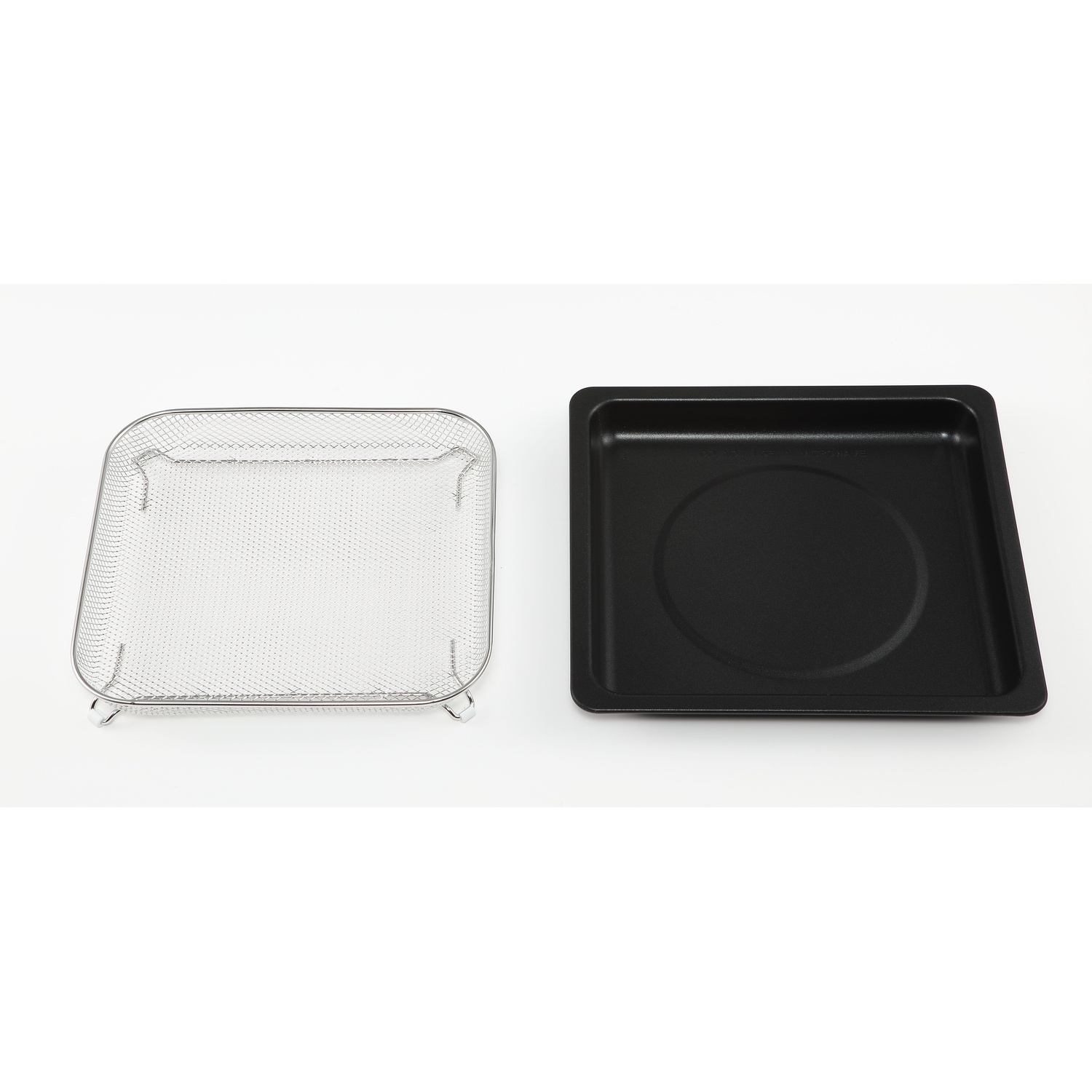 A stainless steel mesh basket and a black tray are on a white surface. The tray has a circular indentation.
