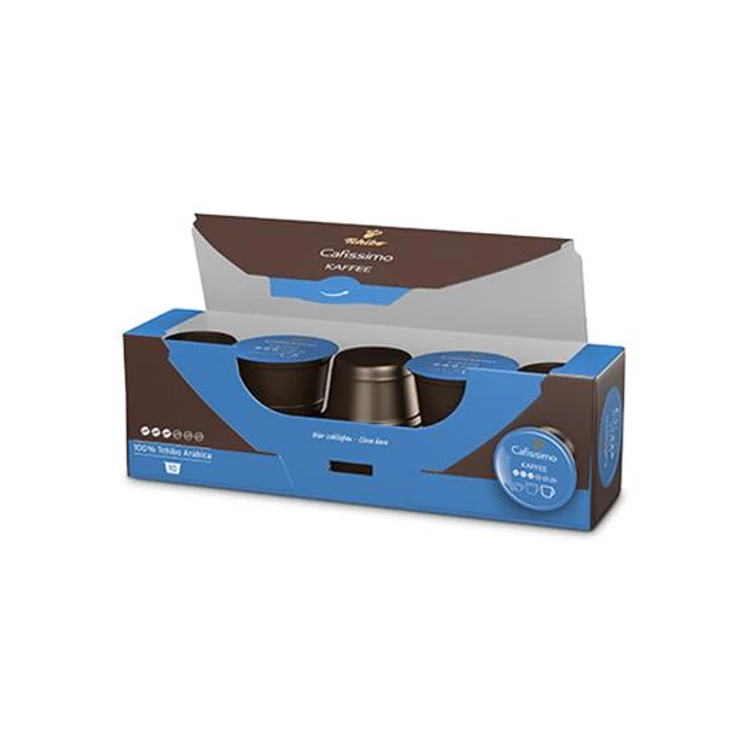 Pudełko kapsułek do kawy, brązowe i niebieskie z nazwą marki. Pudełko jest otwarte, pokazując kapsułki w środku. Białe tło.