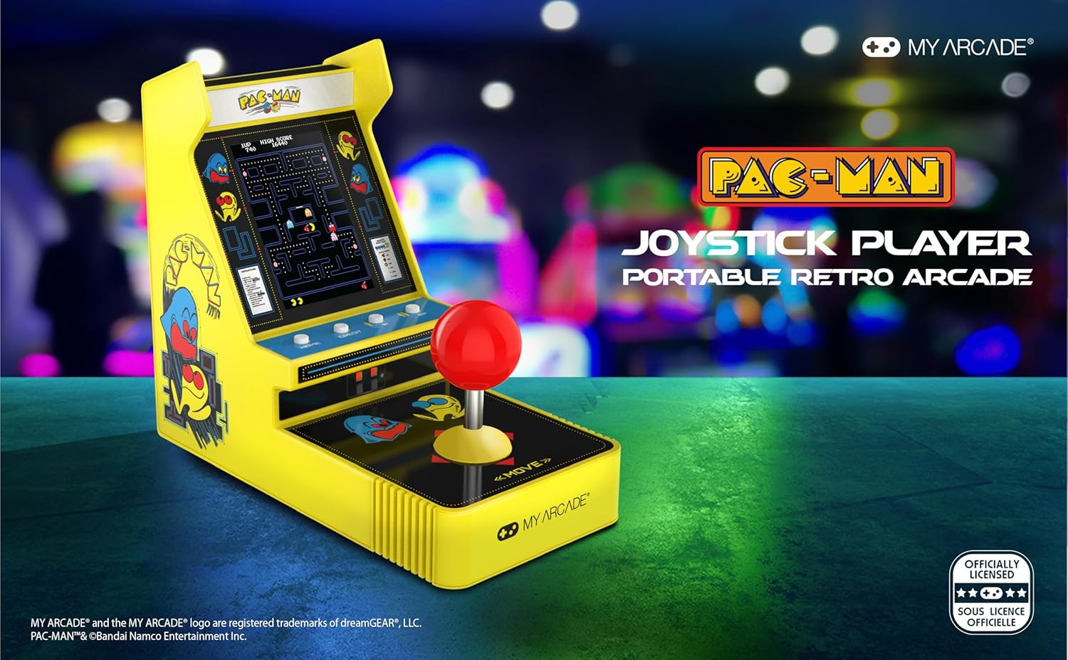 Un joystick d'arcade Pac-Man jaune. L'écran affiche le jeu. Le joystick est rouge. Le texte dit 'JOYSTICK PLAYER'.