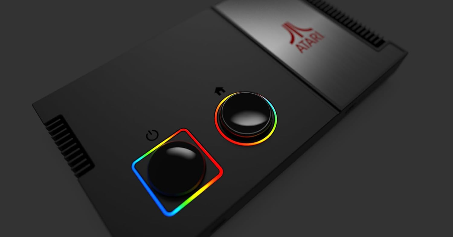 Console Atari noire avec deux boutons, un bouton d'alimentation et un bouton d'accueil. Les boutons ont des lumières arc-en-ciel.