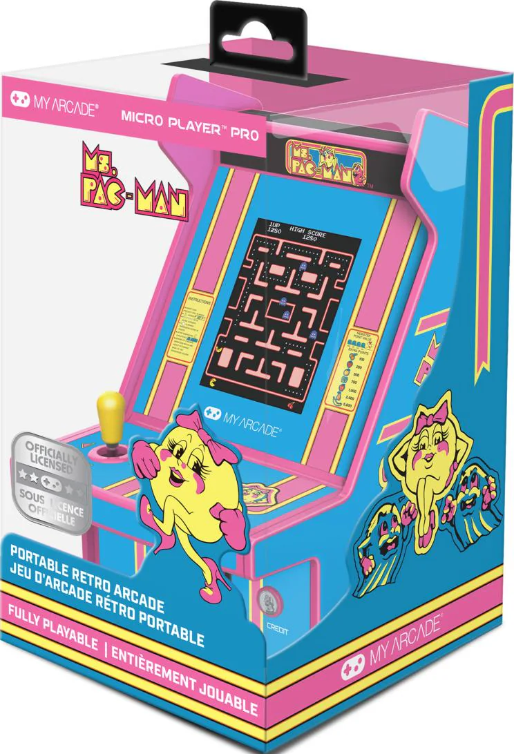 La boîte montre une borne d'arcade Ms. Pac-Man. Elle est bleue, rose et jaune. L'écran affiche un jeu Pac-Man. Ms. Pac-Man est sur la boîte.