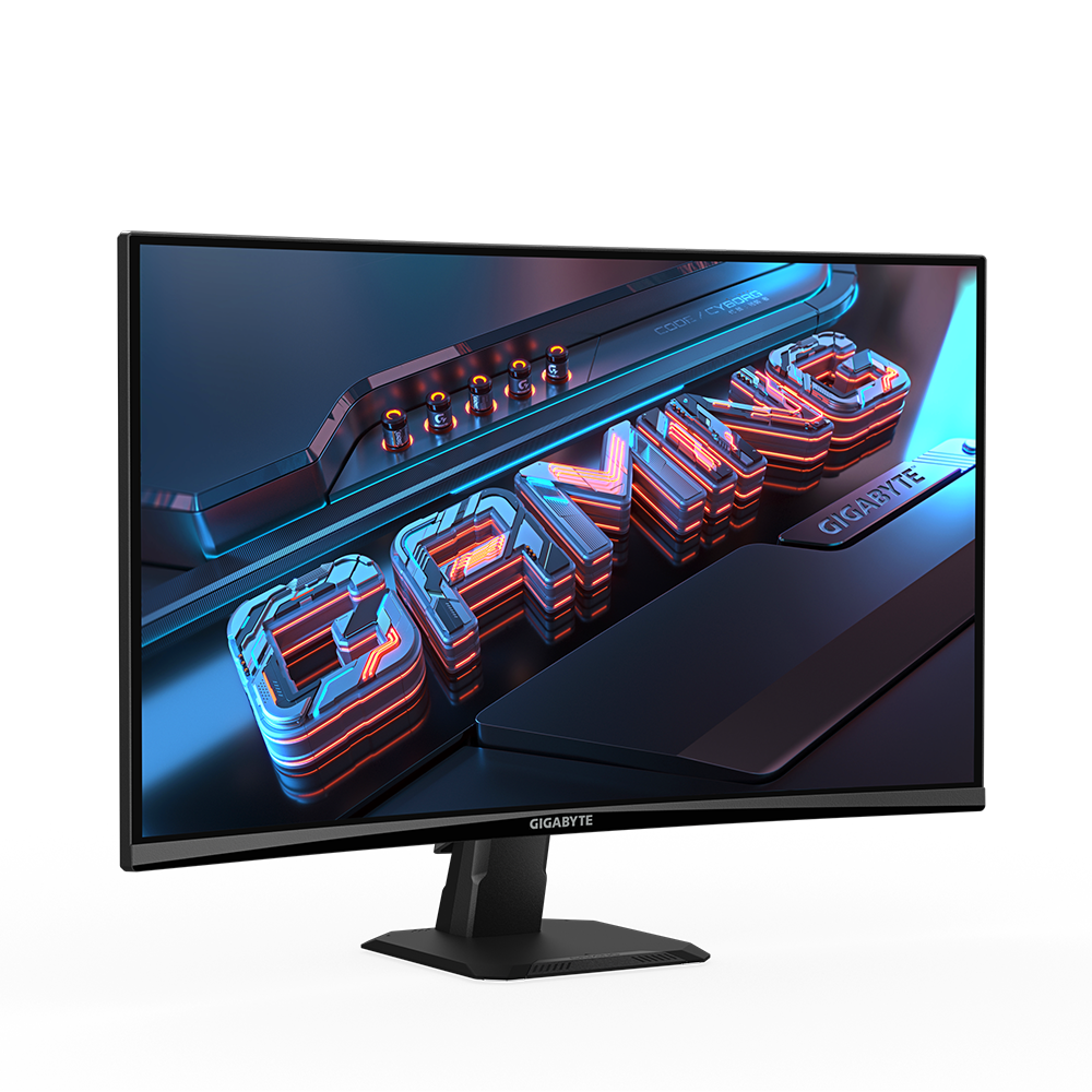 Un monitor gaming muestra 'GAMING' en 3D. Tiene un bisel negro, soporte y un fondo oscuro con detalles en naranja y azul. La marca es GIGABYTE.